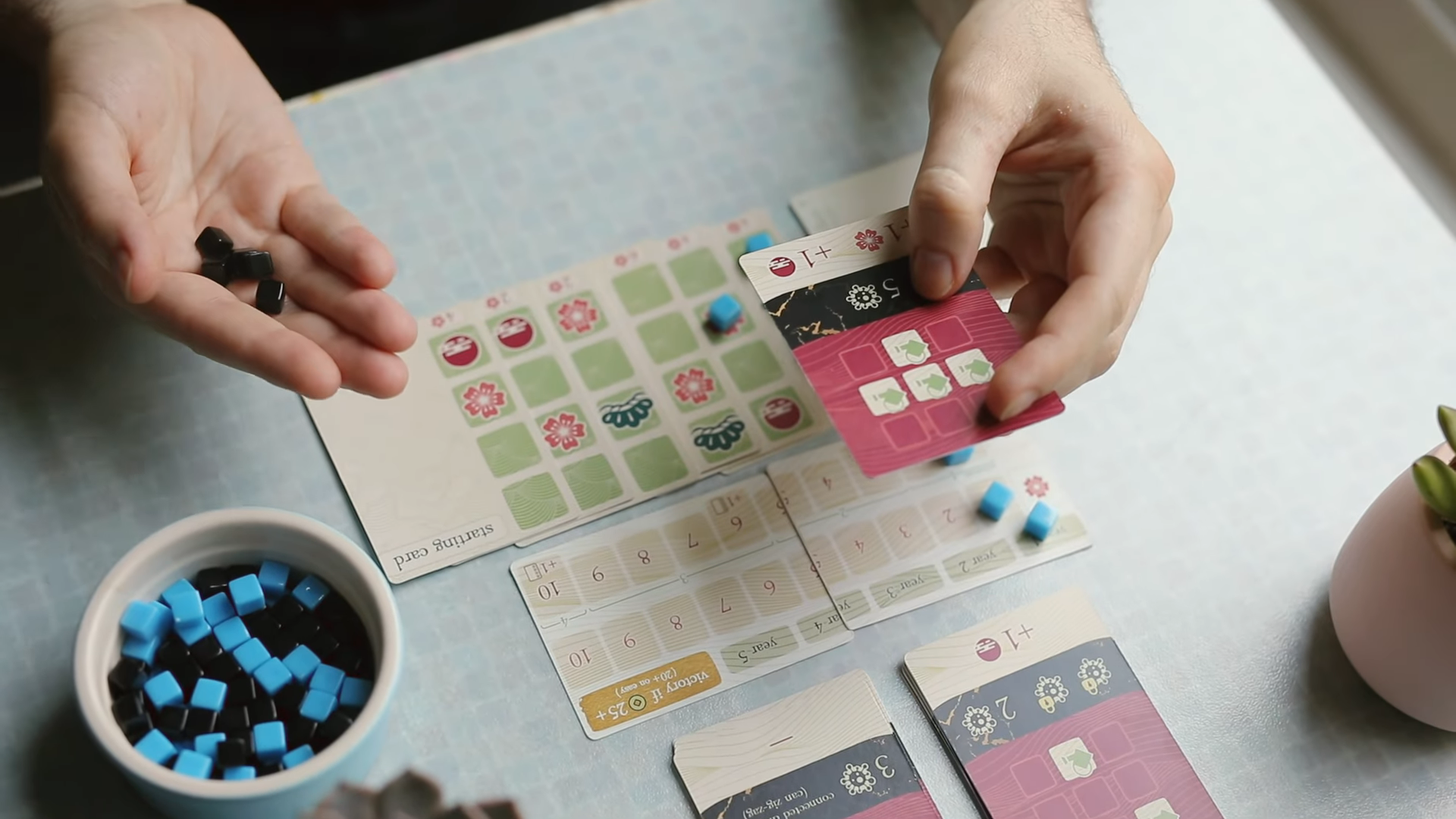 grid-like card game being played on cozy table