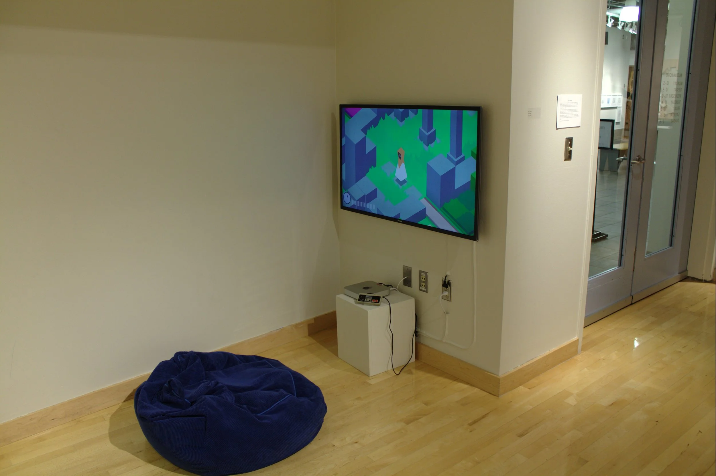 game displayed in art gallery alcove with bean bag